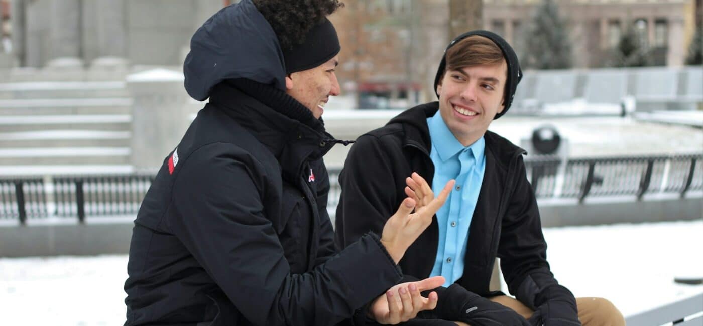 Meta-Kommunikation: Gespräche klären mit Beispielen und Übung Zwei Personen sprechen miteinander auf einer Bank im winterlichen Park.